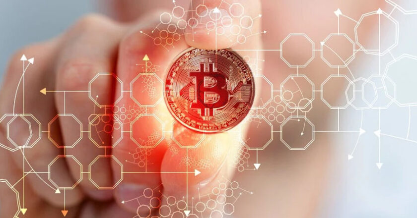 Abstract of man pointing to a bitcoin on a wall display